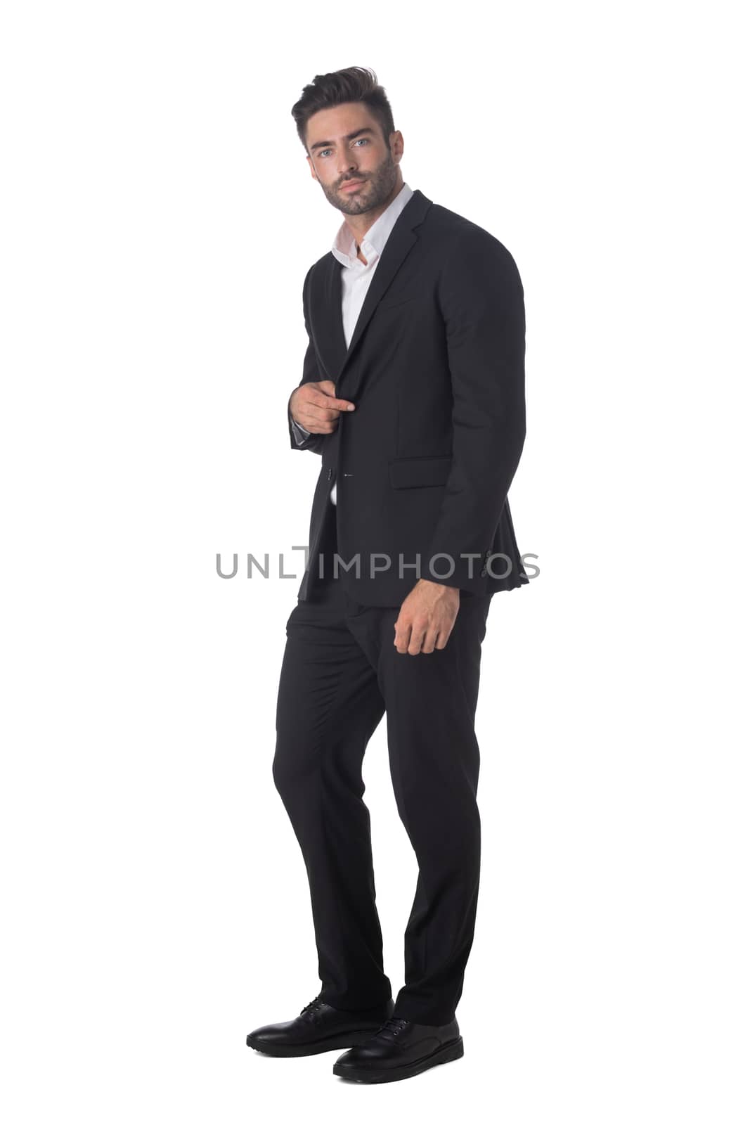 Full length portrait of young handsome business man in black suit studio isolated on white background