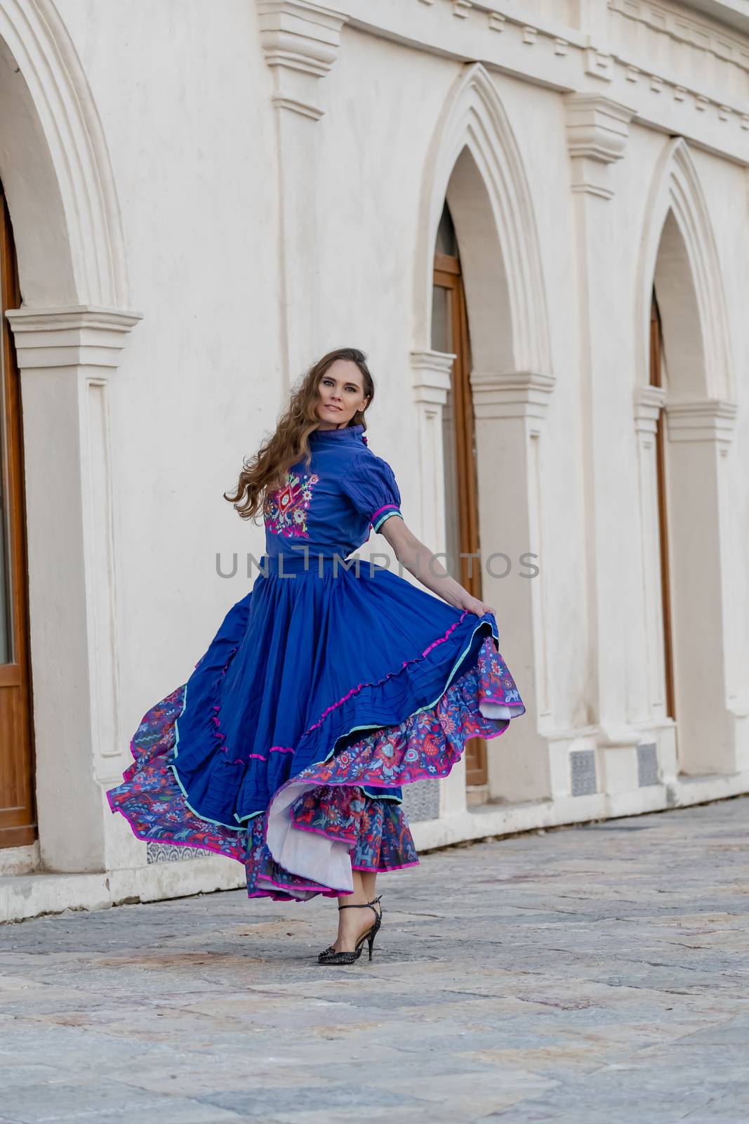 A gorgeous Hispanic Brunette model poses outdoors at a Mexican hacienda