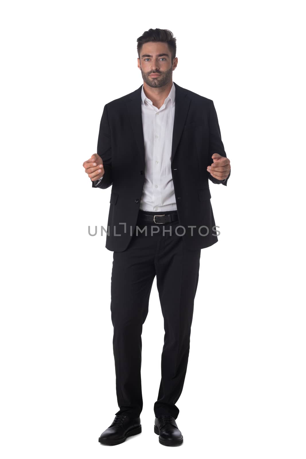 Full length portrait of young handsome business man in black suit holding something in hands studio isolated on white background