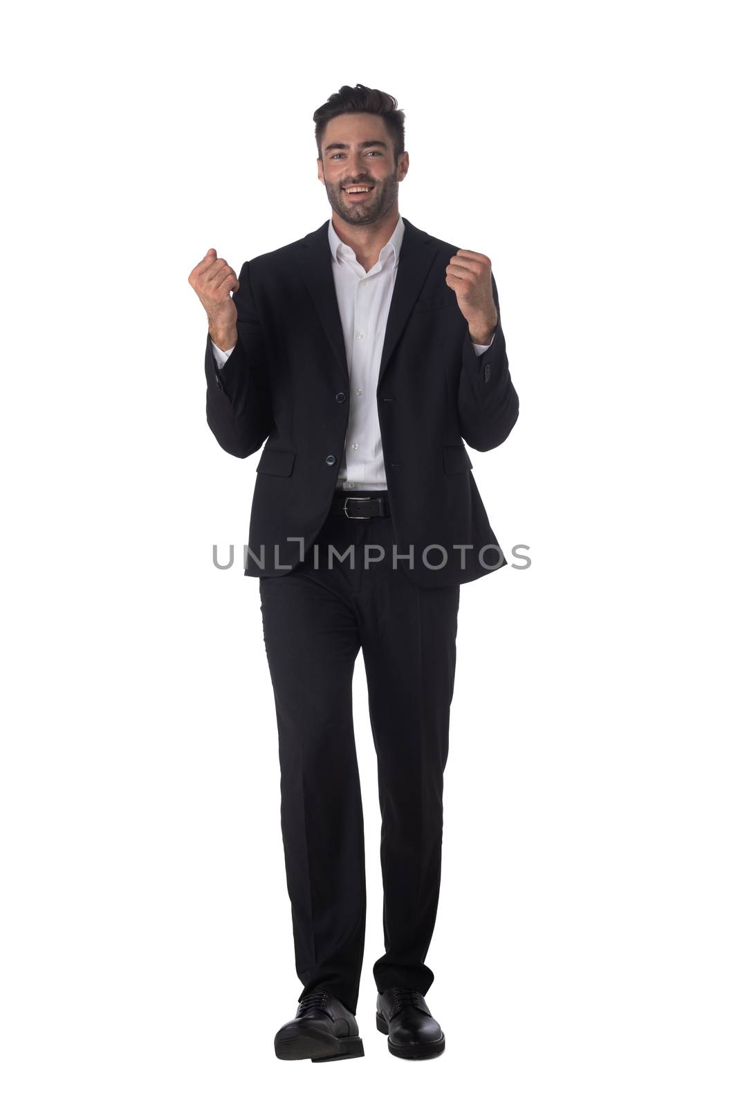 Full length portrait of successful excited happy business man in black suit looking at camera hold fist ok yes gesture studio isolated on white background