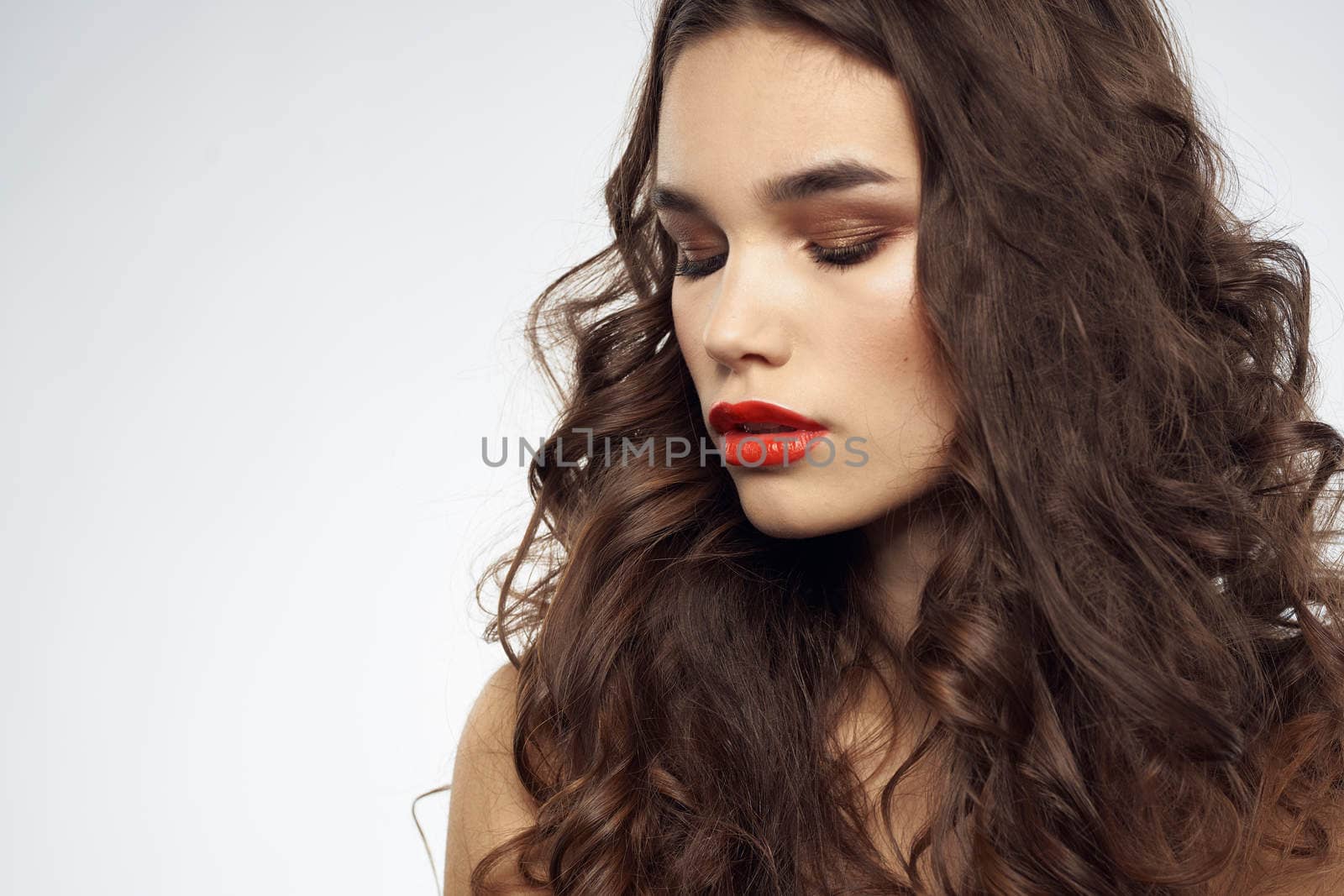 woman with bare shoulders wavy hairstyle glamor makeup light background by SHOTPRIME