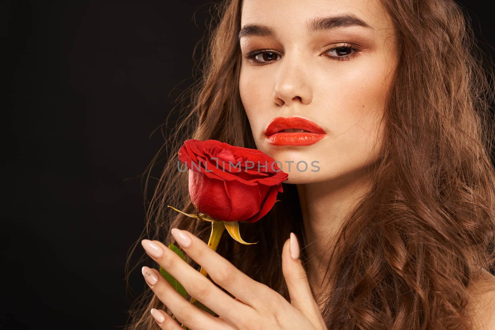 woman with a red rose on a dark background long hair makeup red lips by SHOTPRIME