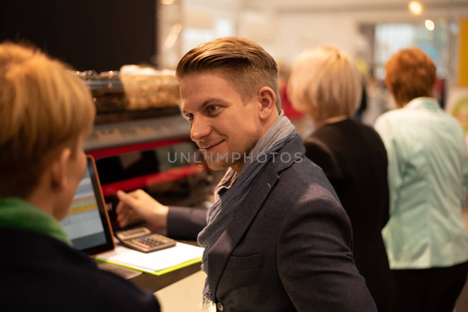 bition center. Czech Republic. Sales person discussing a product he is offering to a potential client at a convention trade center. Brno Exhibition center. Czech Republic by gonzalobell
