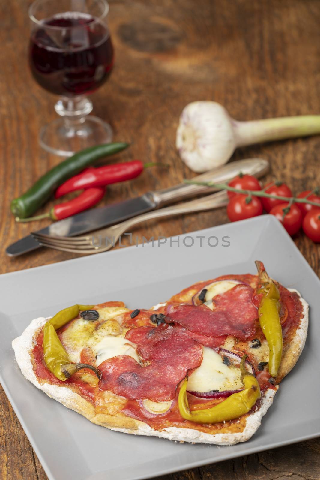 closeup of a heart shaped pizza by bernjuer