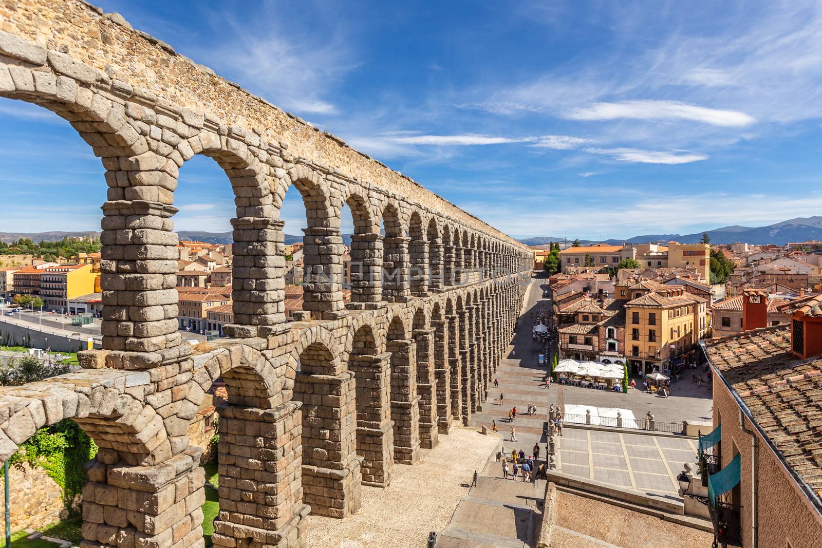 Roman aqueduct bridge and city panorama, Segovia, Spain by ambeon