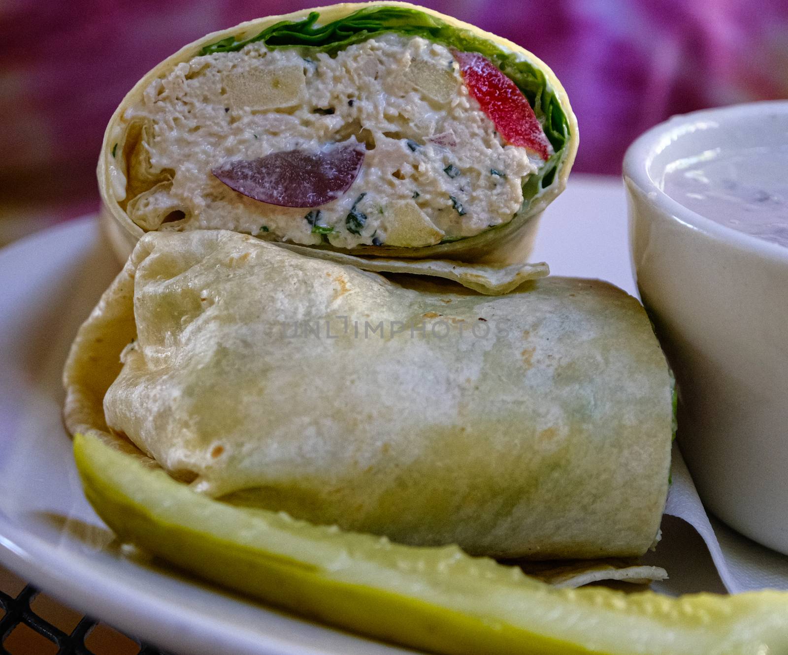 A delicious Chicken Salad Wrap with pickle spear