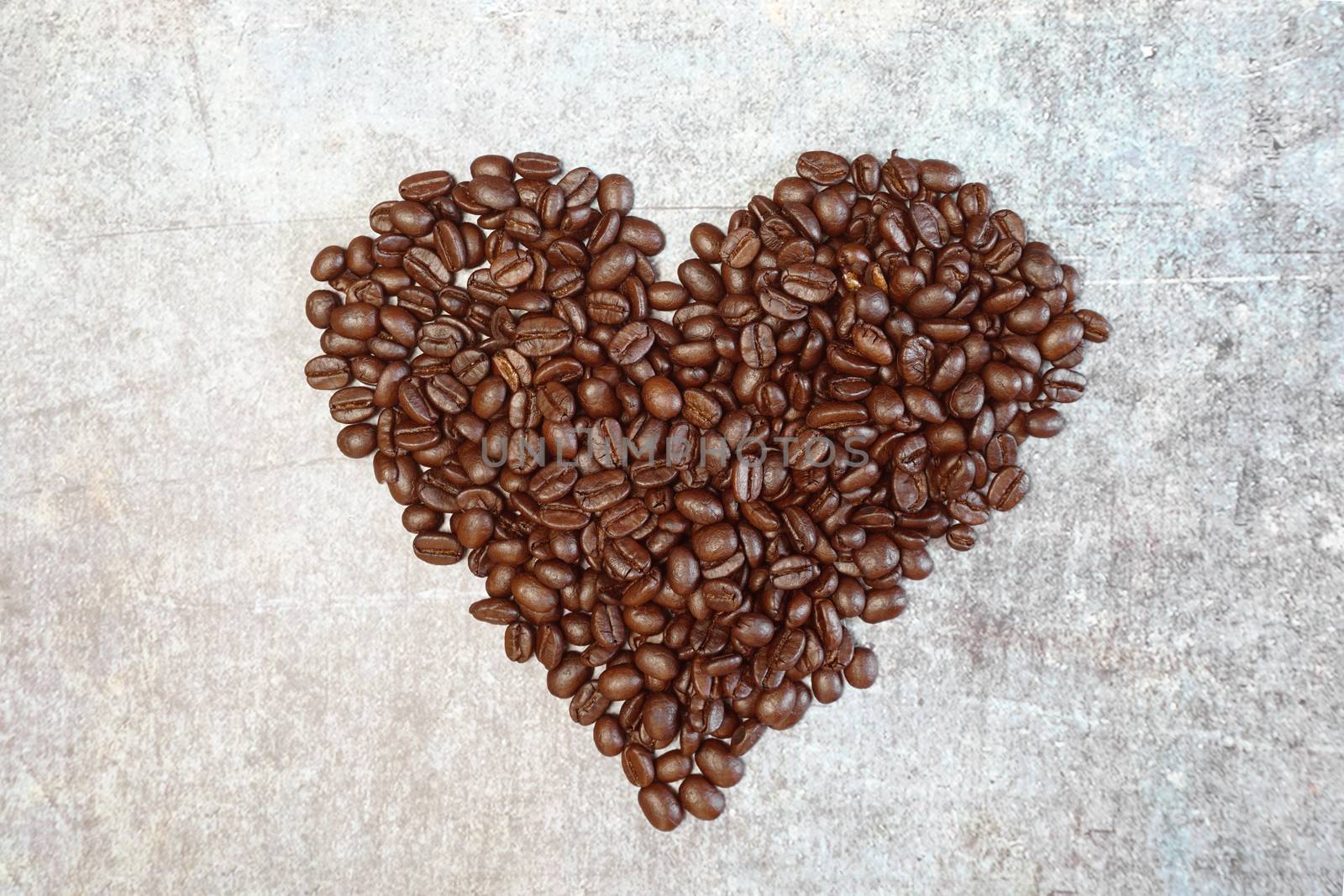 Roasted coffee beans in heart shape.