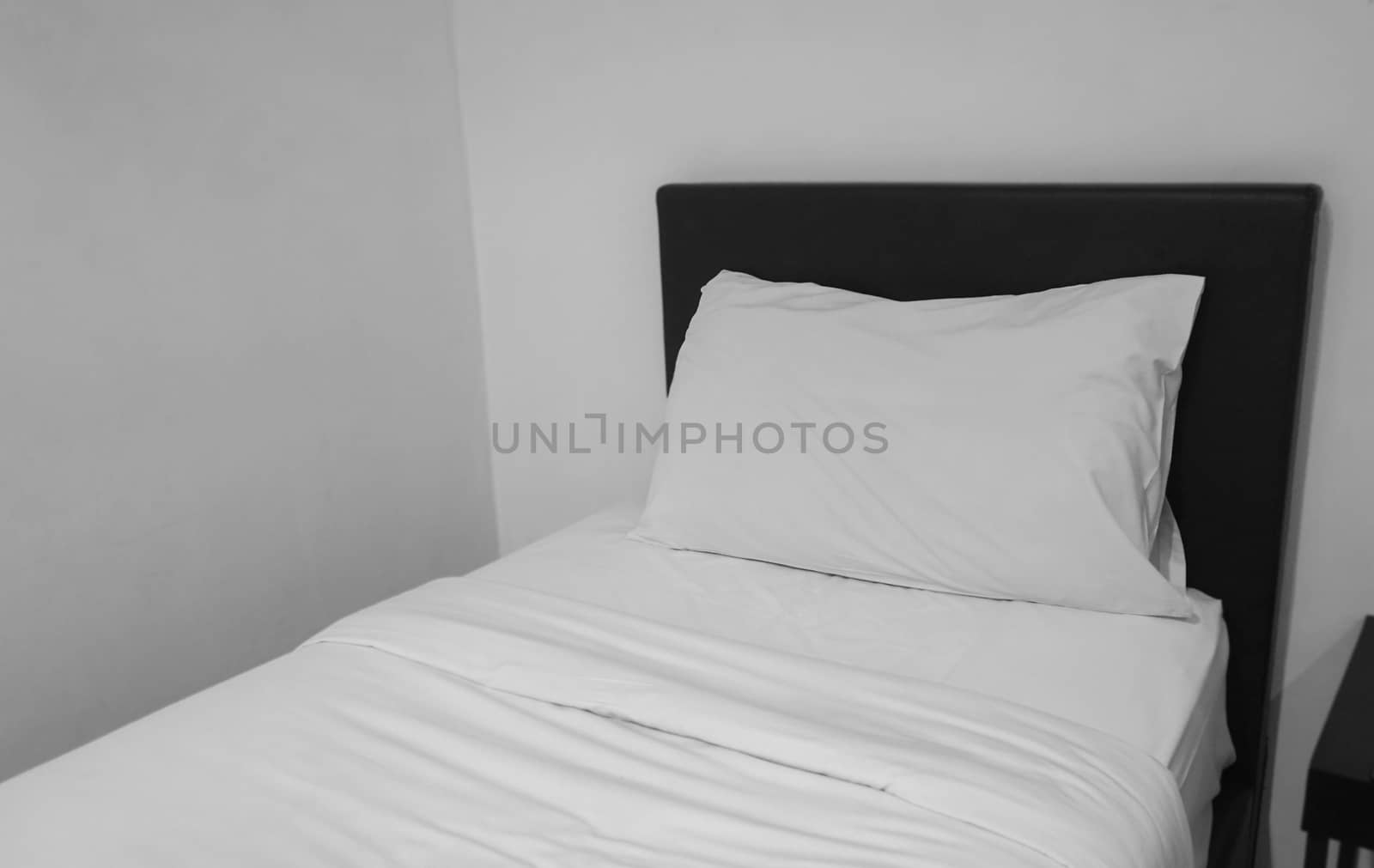 White pillows and blanket on bed by Urvashi-A