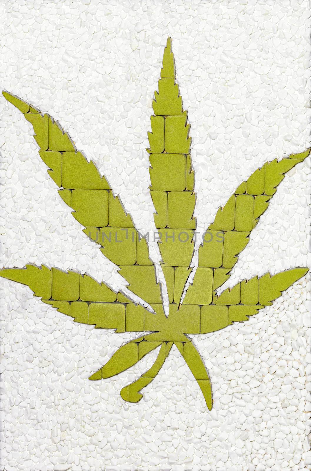 The green cannabis leaf is lined with paving stones. Medical marijuana cultivation concept. by Sergii