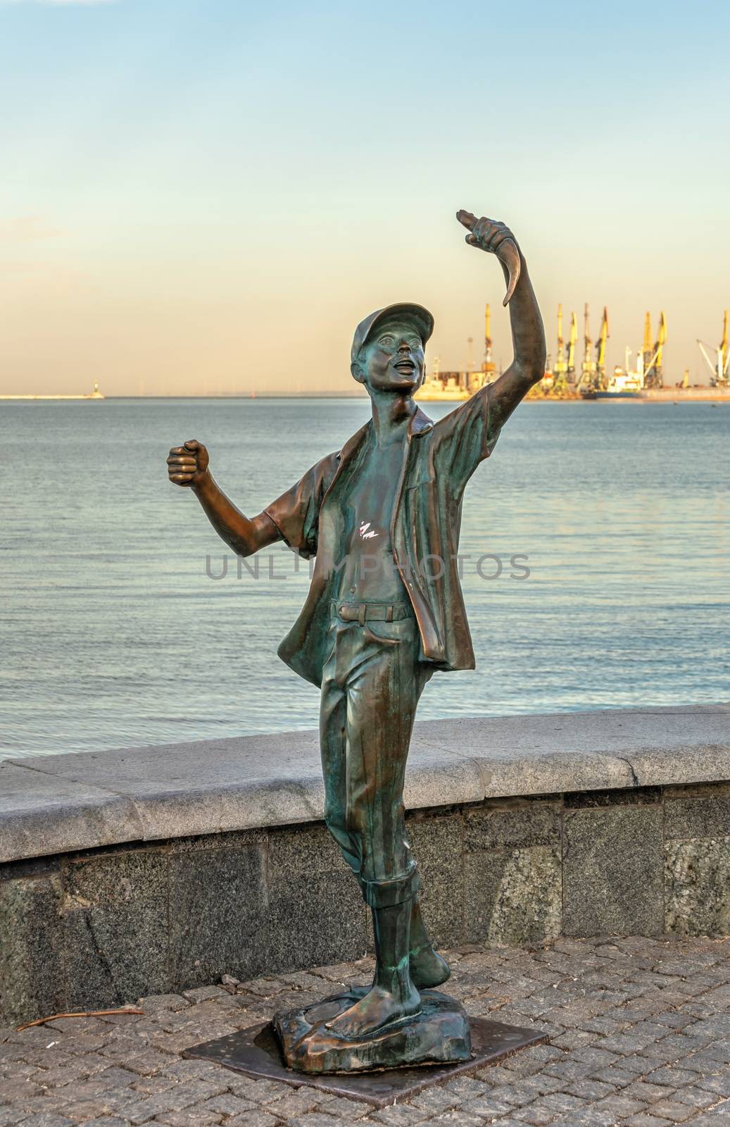 Berdyansk, Ukraine 07.23.2020. Monument to the fisherman on the embankment of Berdyansk, Ukraine, on an early summer morning