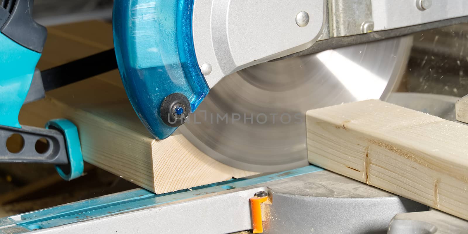 Carpenter work with circular saw for cutting wood bar, the man sawed bars, construction and home renovation. Carpenter work concept by PhotoTime