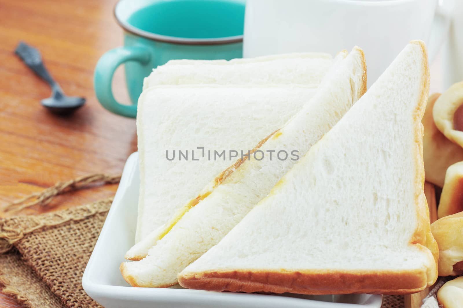 breads and cup of coffee on a wooden.