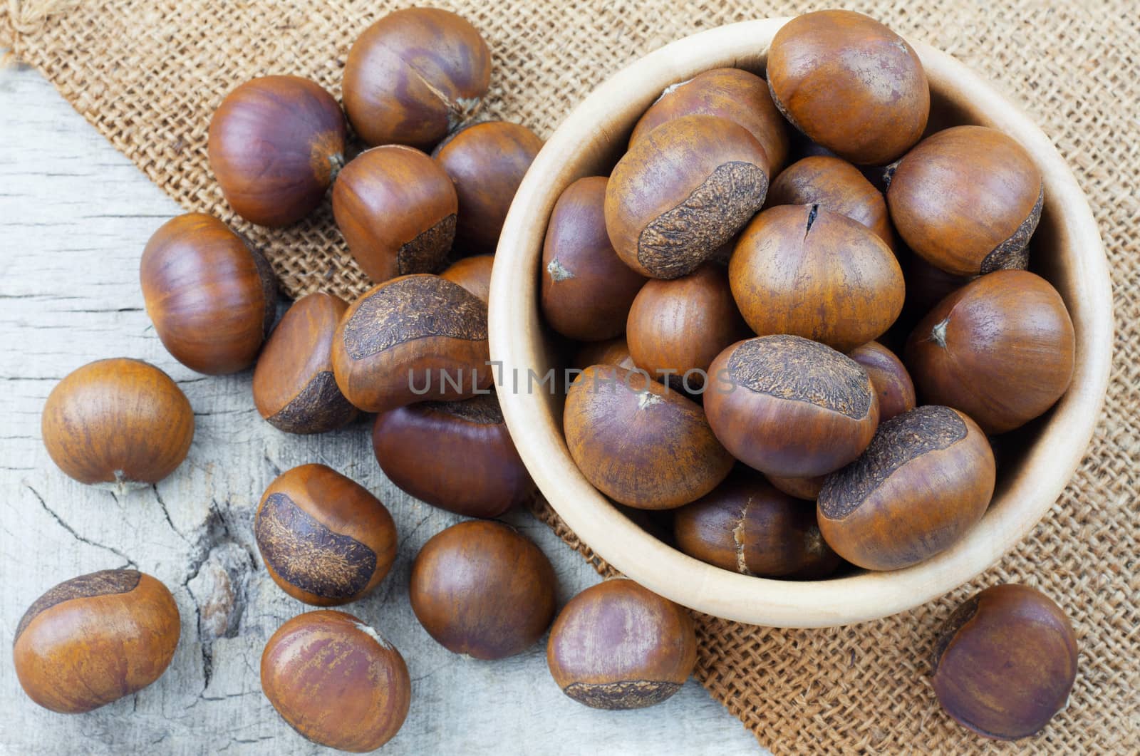 chestnuts on sackcloth and wooden floor.