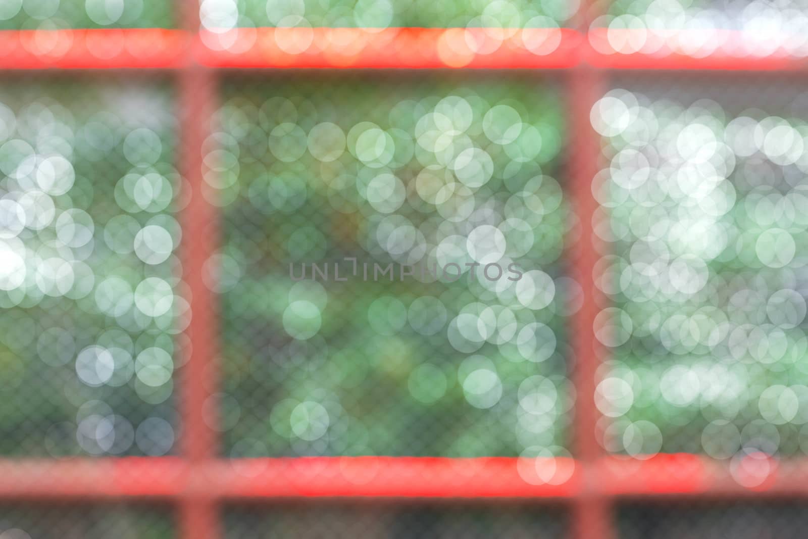 Steel cage of zoo with blurred image.