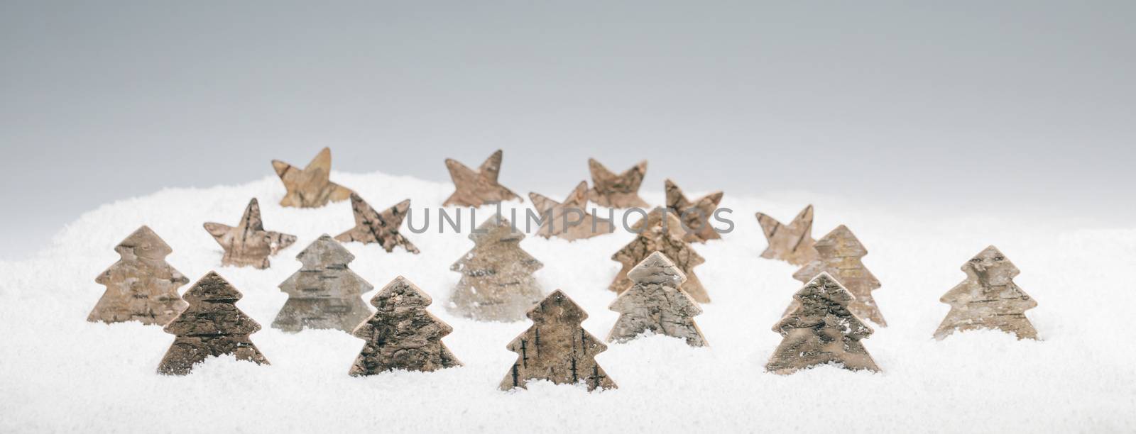 Wooden eco-friendly Christmas decor in snow, trees and stars made of birch bark