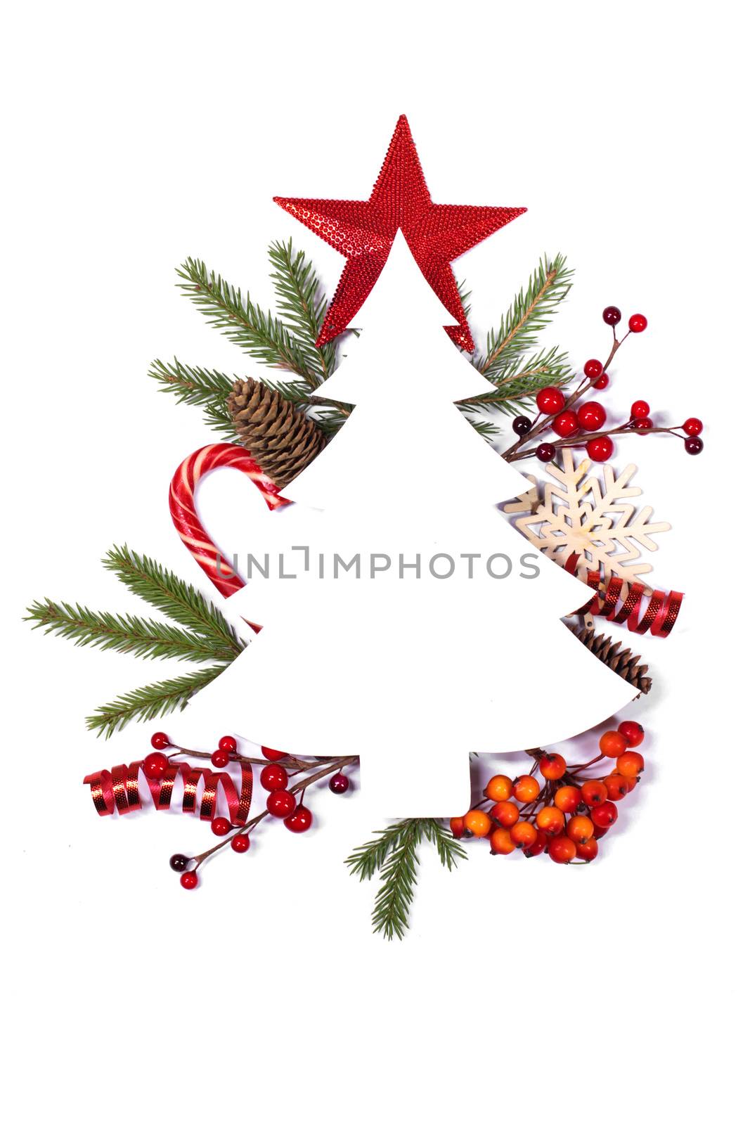 Christmas white fir tree shaped blank card with copy space and decor of fir tree branch bauble cones red holly berry isolated on white background