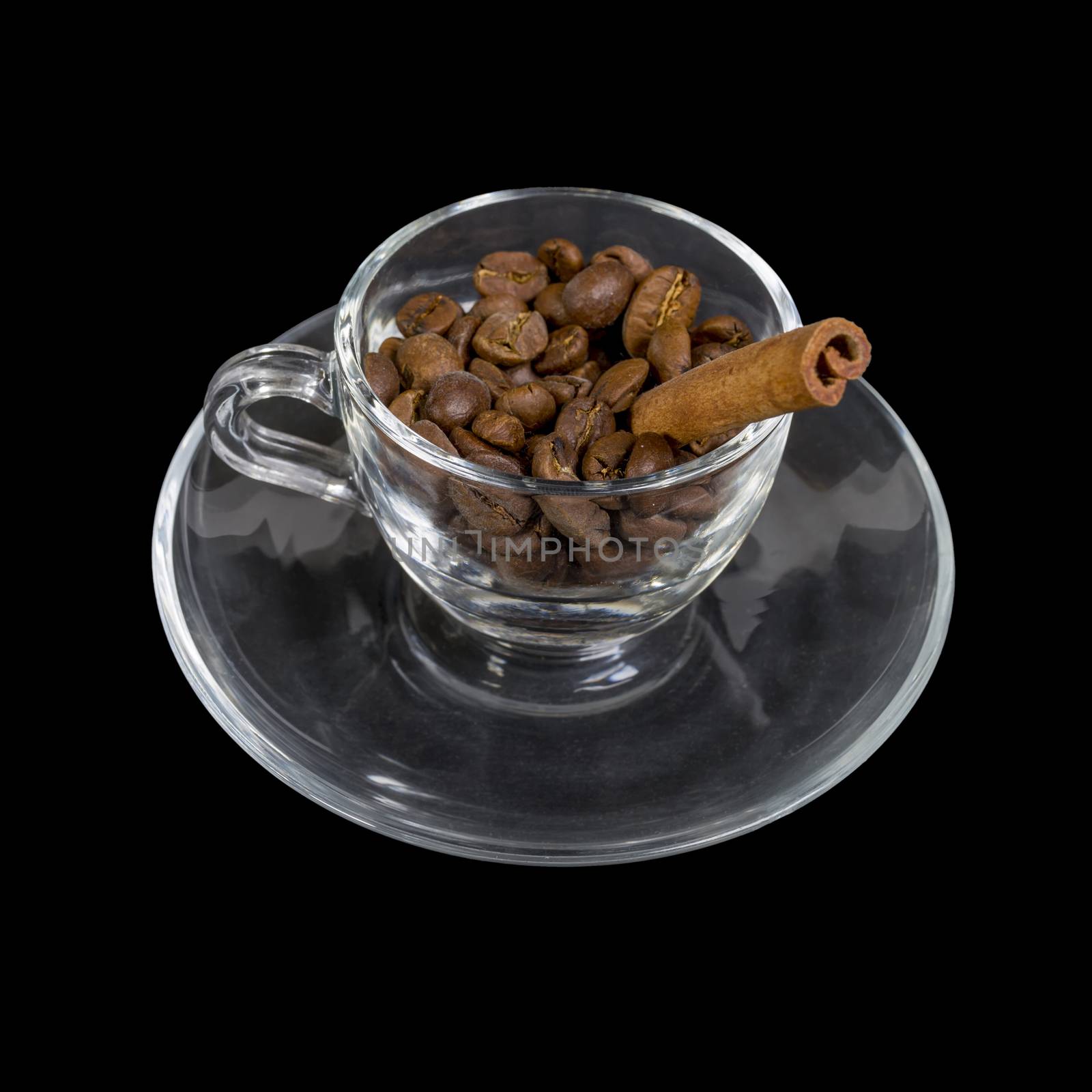 A cup of coffee. Glass cup on a saucer with coffee grains and a vanilla tube. Isolated on a black background.