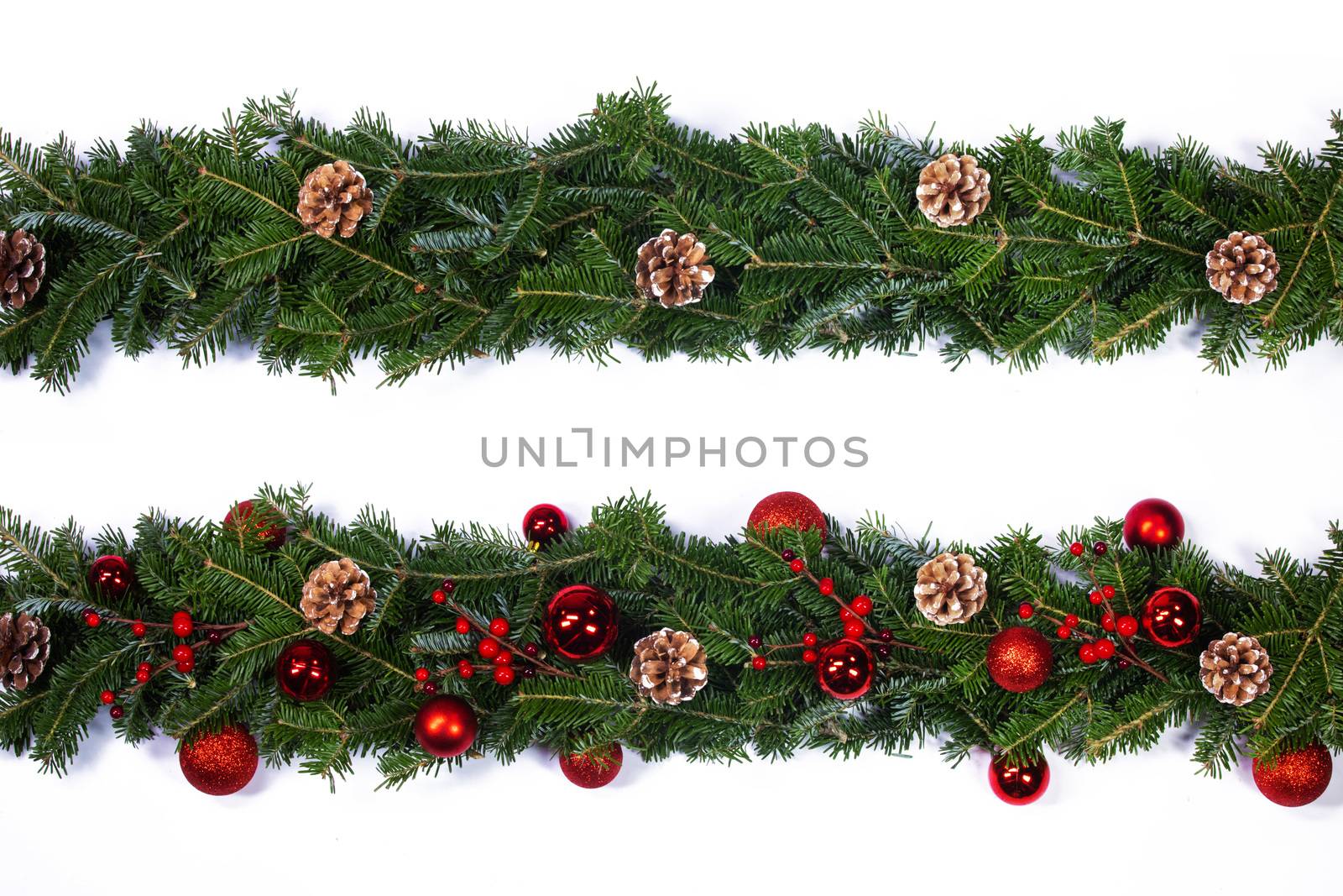 Christmas frame decor of fir tree branch cones red holly berry baubles isolated on white background