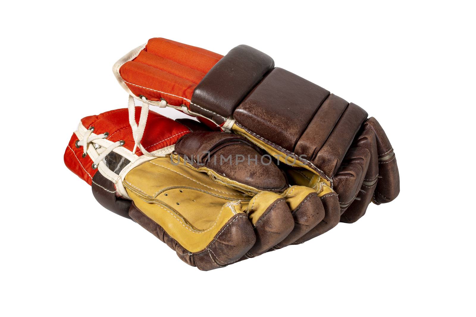 Old red hockey gloves for goalkeeper. Isolated over white background. The concept of the game of hockey and hockey sport.