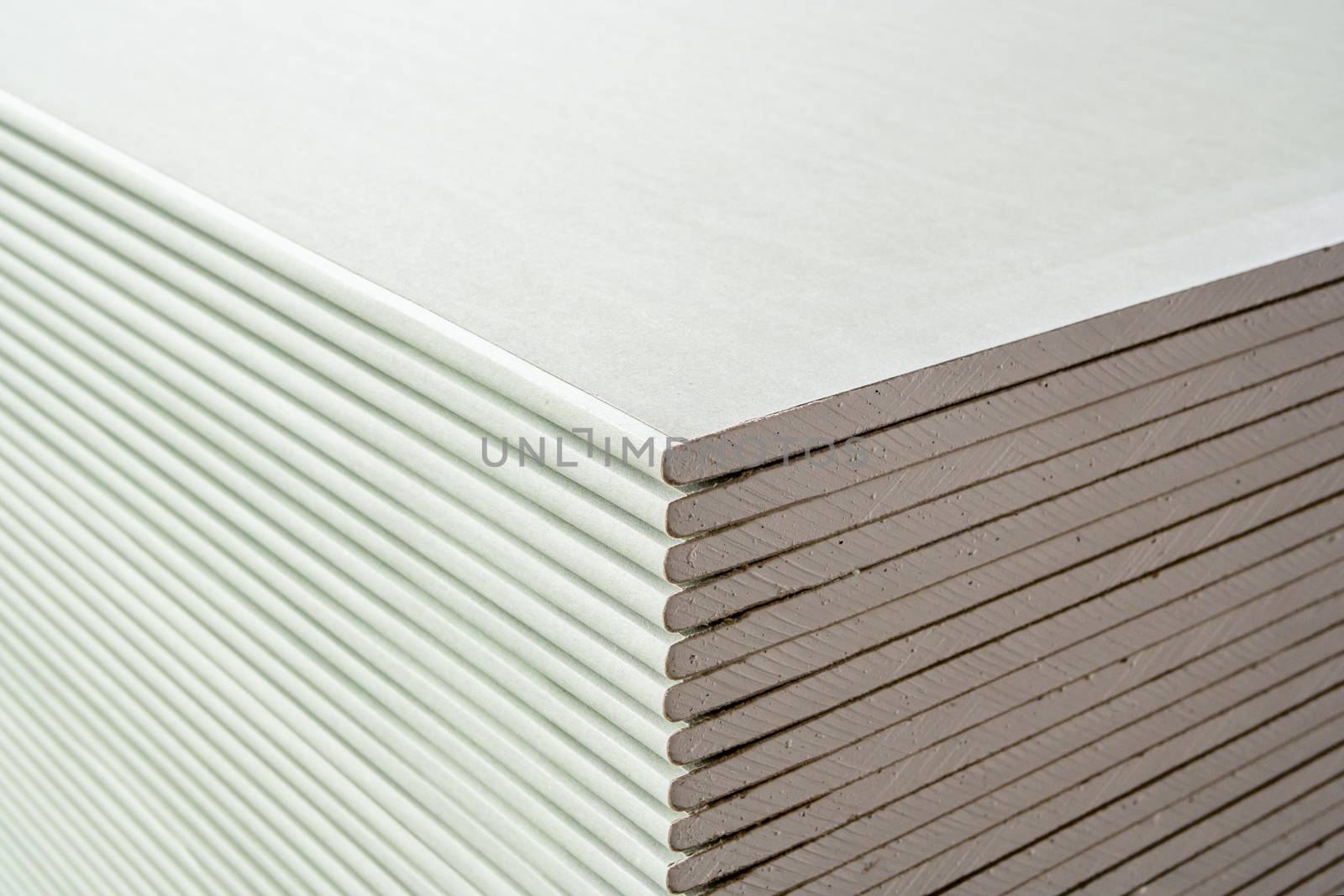 building material. drywall sheets are stacked on top of each other.