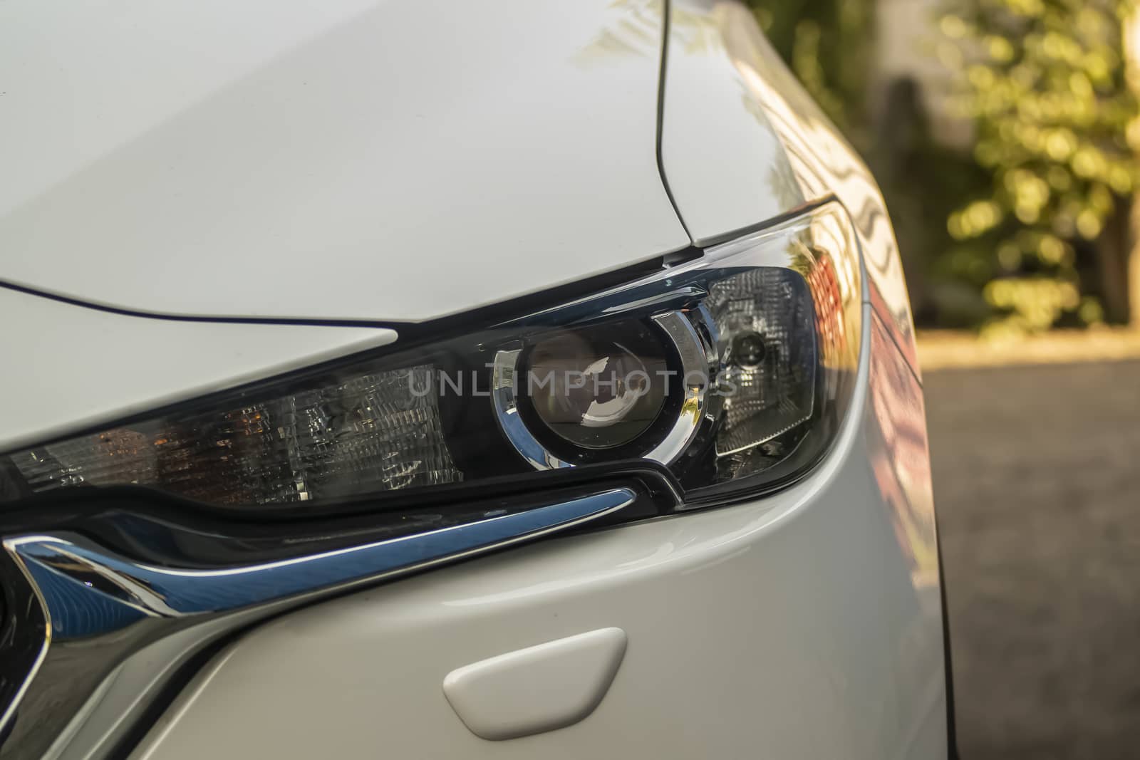 The headlight of a modern car, close-up. by Akmenra