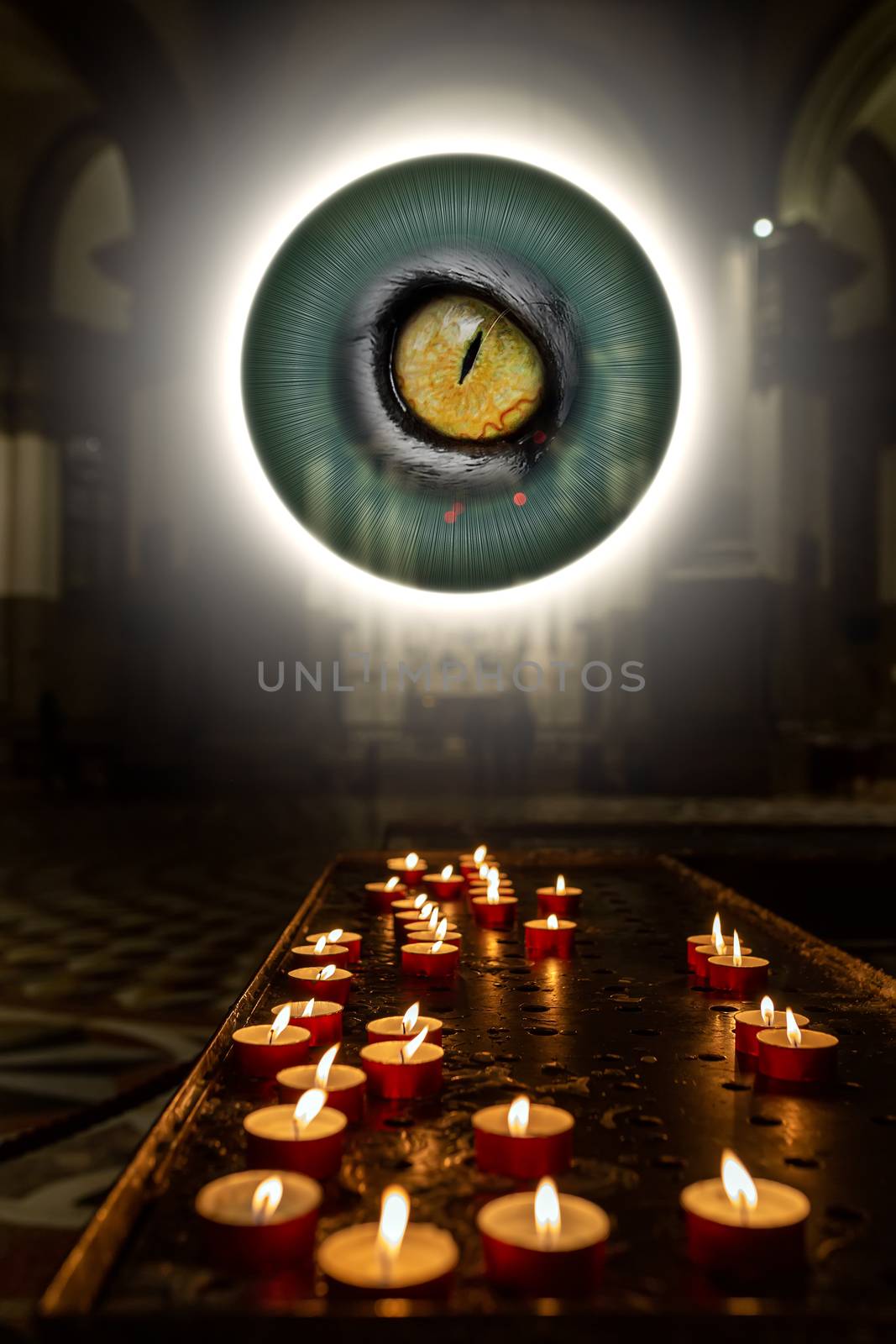 The concept of occultism astrology magic. Candles are burning in a dark church. A magical circle shines above with an eye inside from which rays of light emanate.