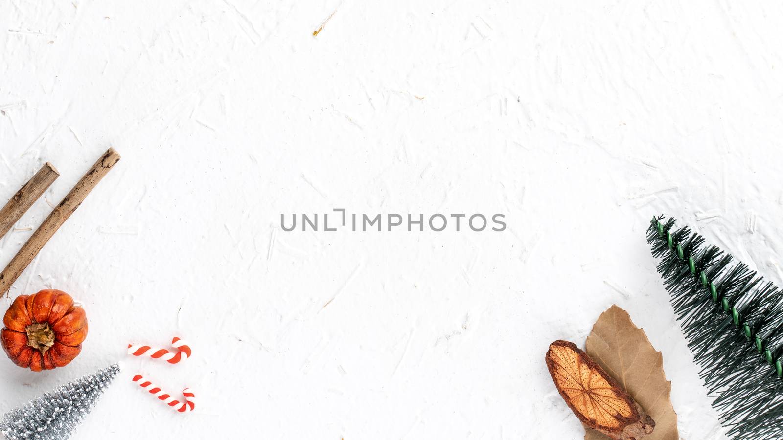 Top view of Christmas holiday decoration ornament composition with Christmas tree, gift star, gingerbread man flat lay with copy space isolated on white background.