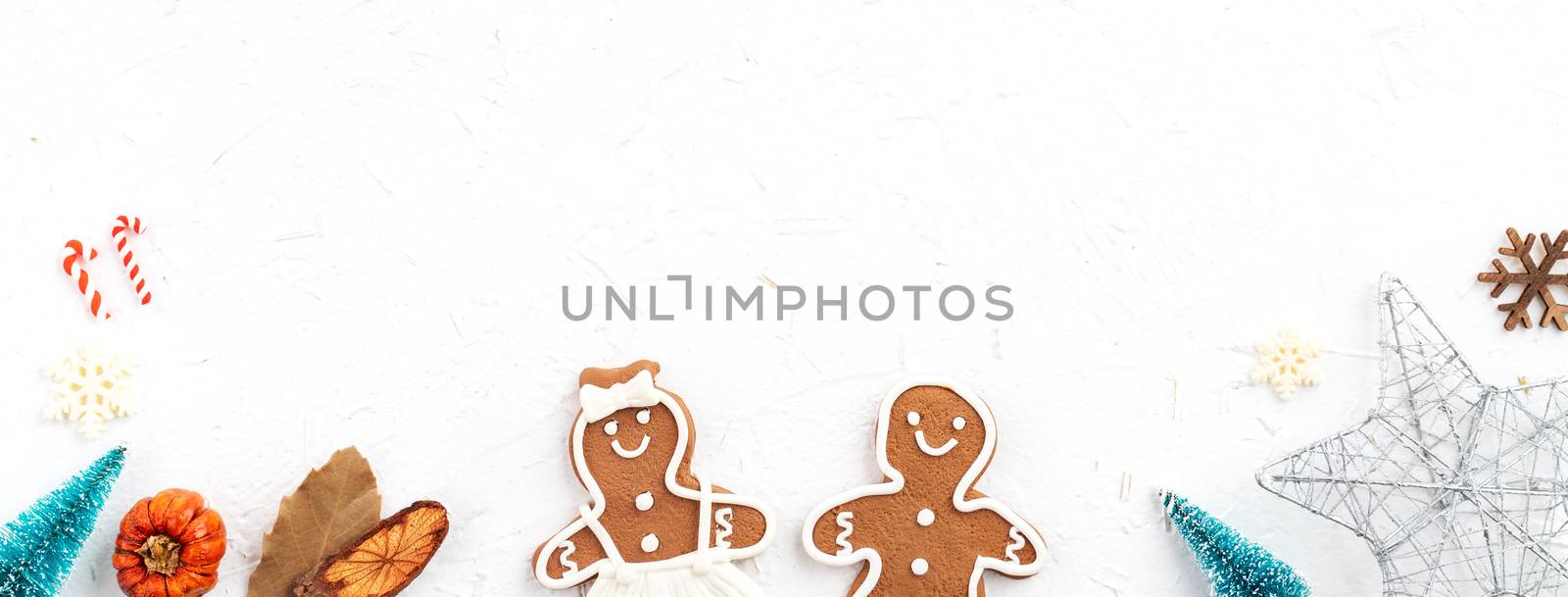 Top view of Christmas holiday decoration ornament composition with Christmas tree, gift star, gingerbread man flat lay with copy space isolated on white background.