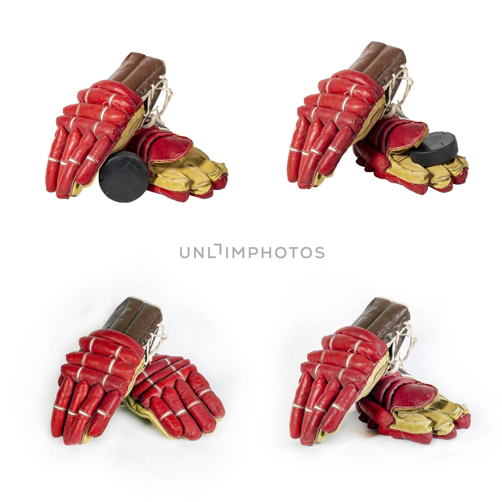 Set of old red hockey gloves for goalkeeper. Isolated over white background. Hockey puck. The concept of the game of hockey and hockey sport. Close-up.