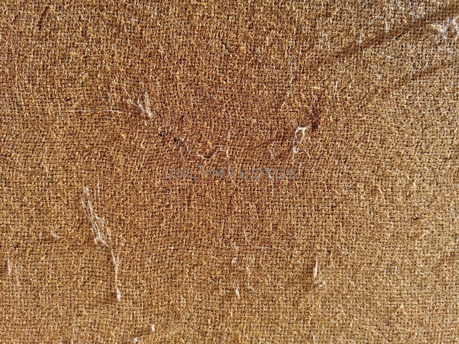 Rough fabric of light brown color, closeup, background texture.