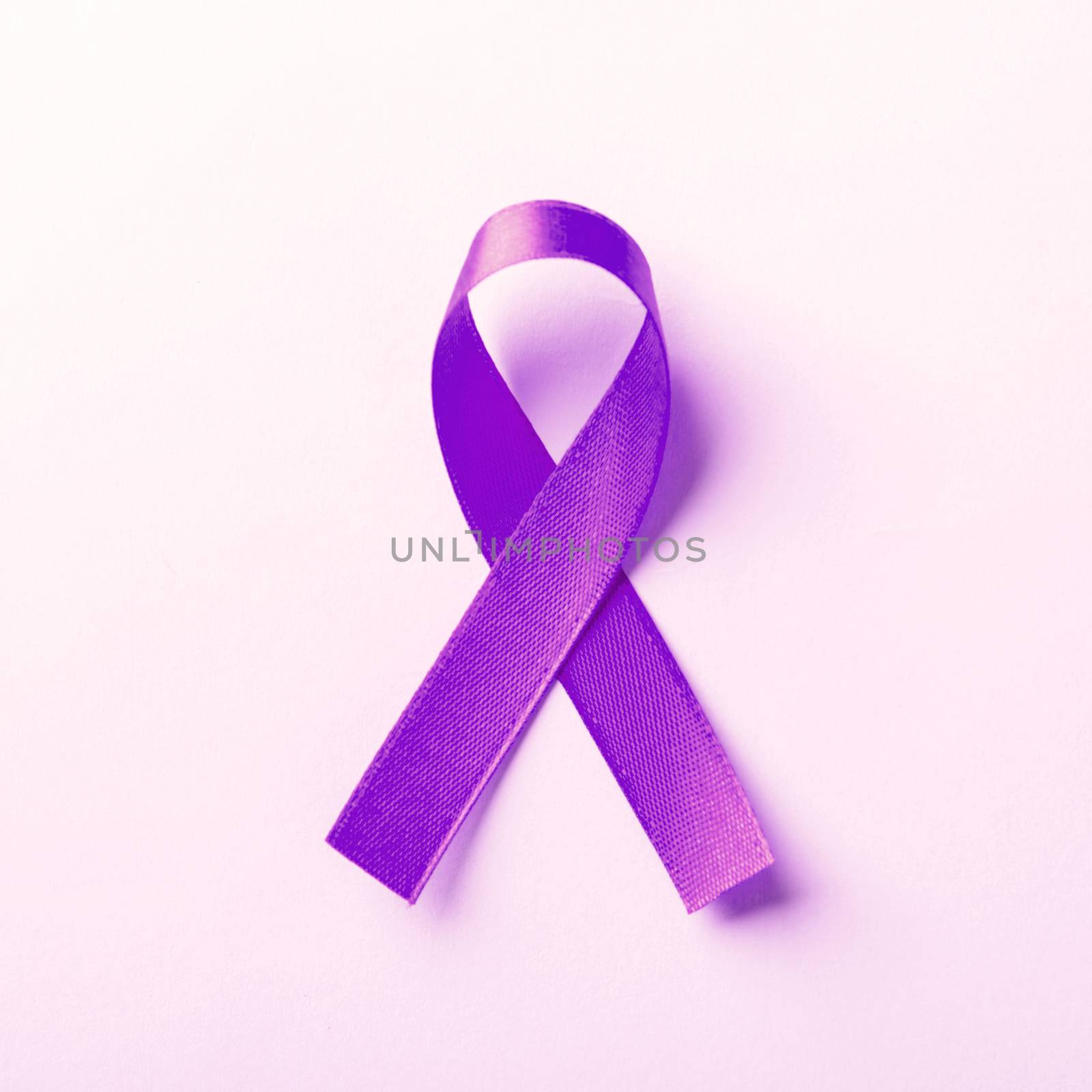 National Epilepsy or Alzheimer disease Day Concept. Purple ribbon symbol of Pancreatic cancer awareness and world Lupus Day and world cancer isolated pink background