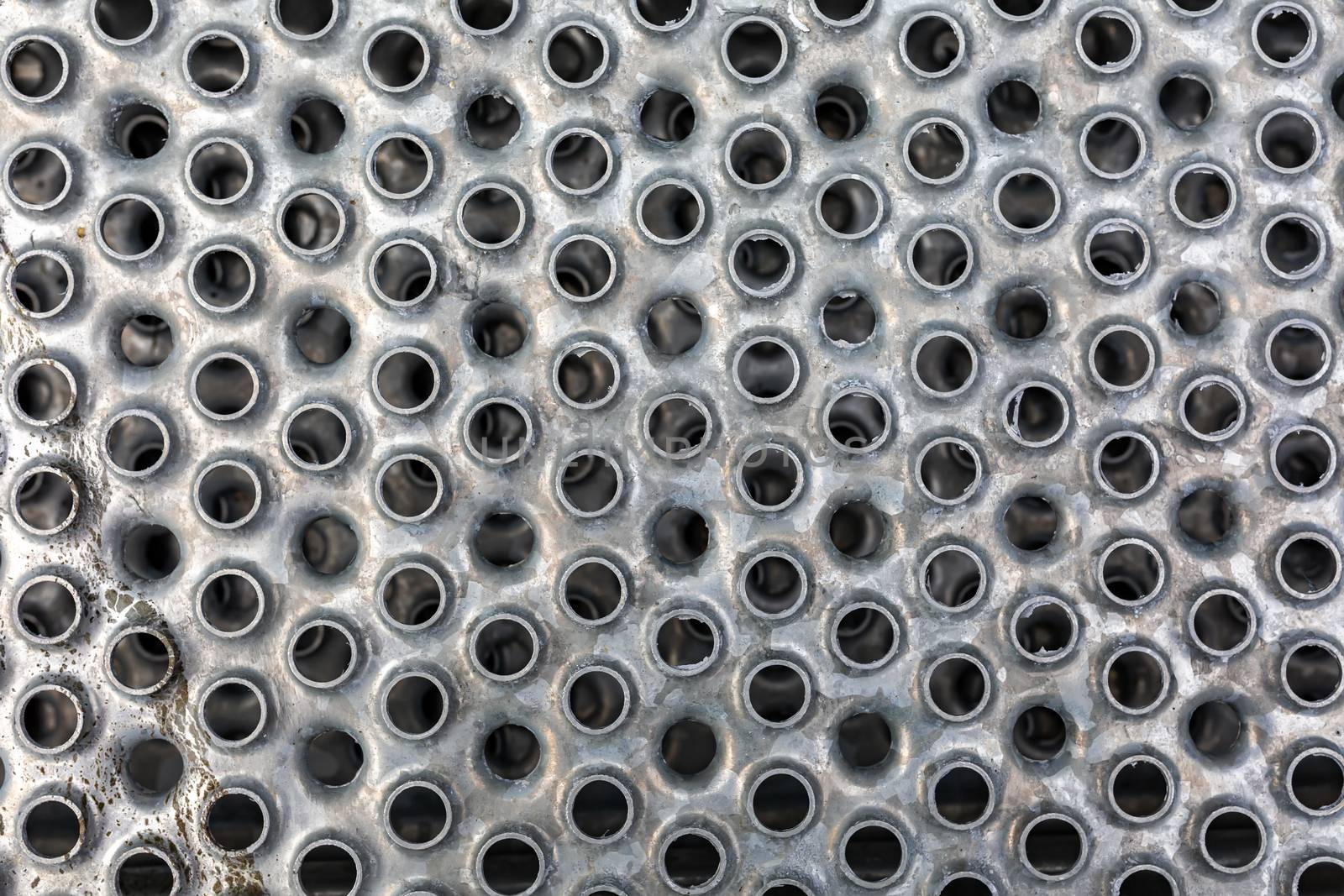 Iron sheet of gray color with round holes - background texture closeup by 977_ReX_977