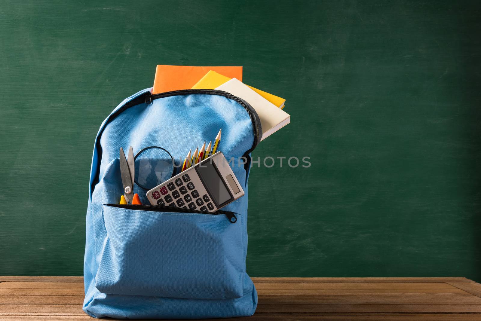 Front of stylish school bag backpack and stationery by Sorapop