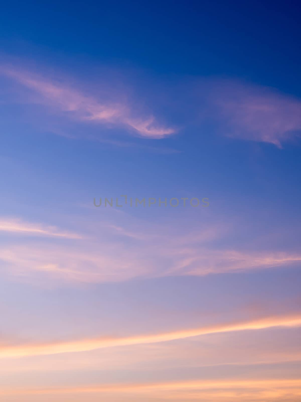 White fluffy clouds in the blue sky with morning light from the sunrise