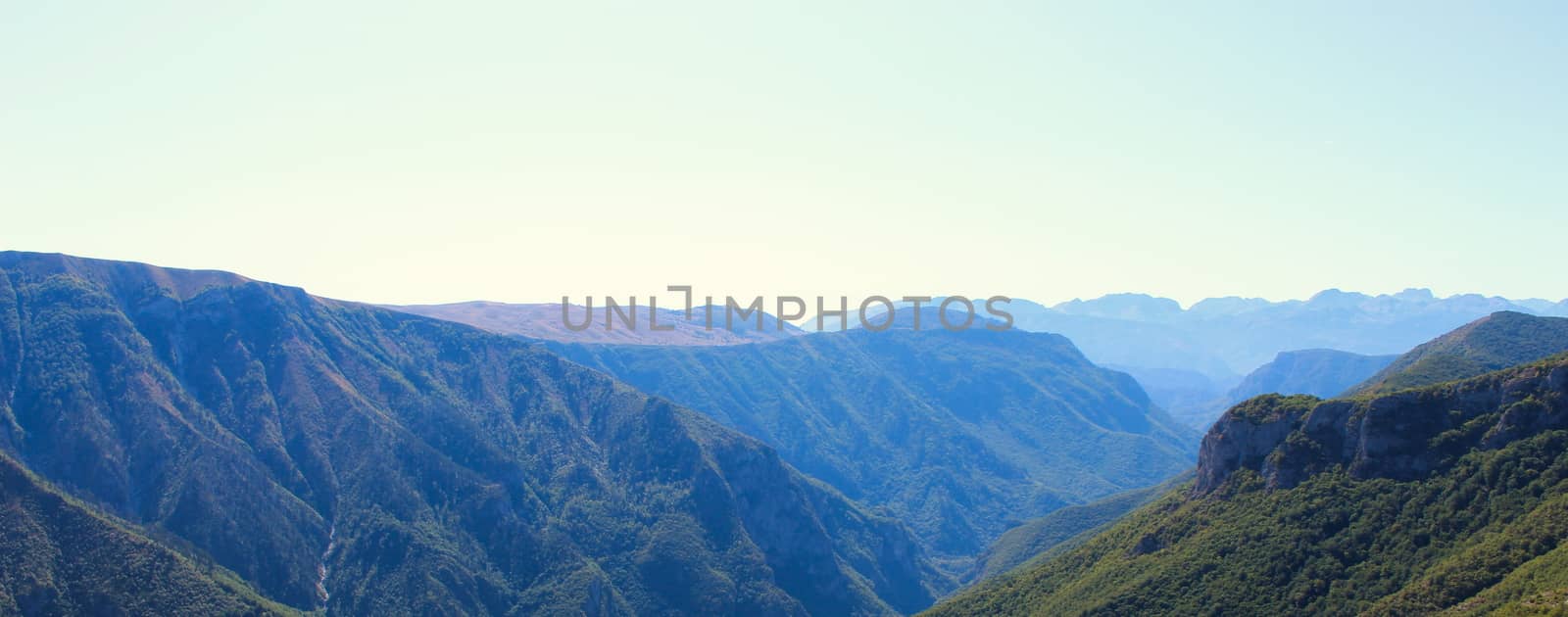 Banner of mountain peaks disappearing in the distance on a beautiful sunny day. by mahirrov