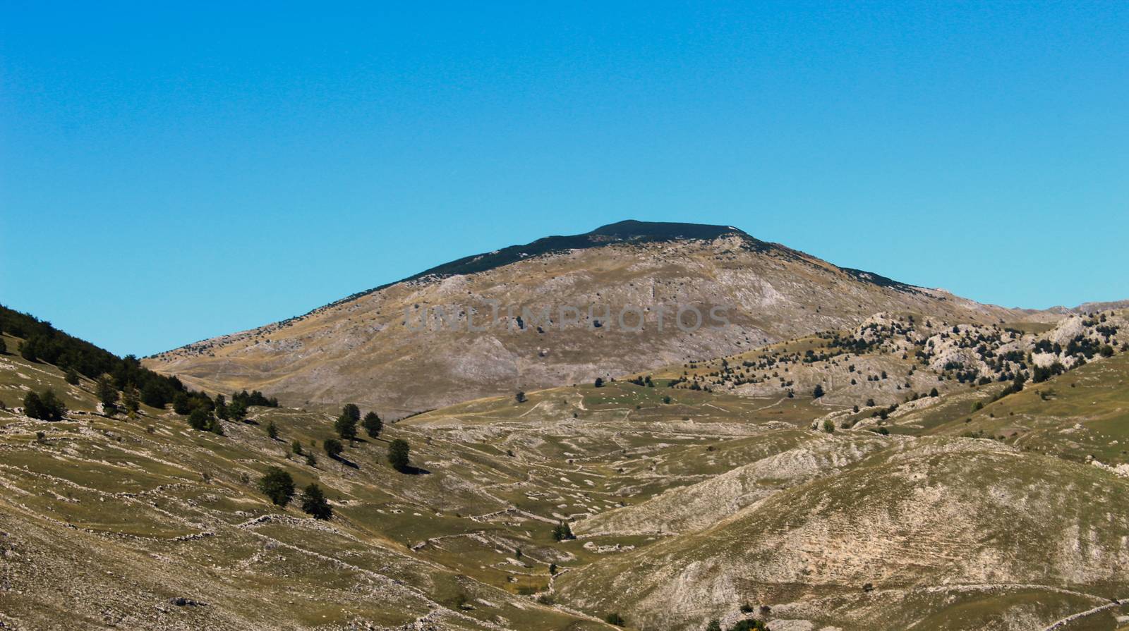 Magnificent mountain landscape of Bjelasnica mountain above the old Bosnian village of Lukomir. Meadows and pastures fenced with stone that mark individual plots of land. by mahirrov