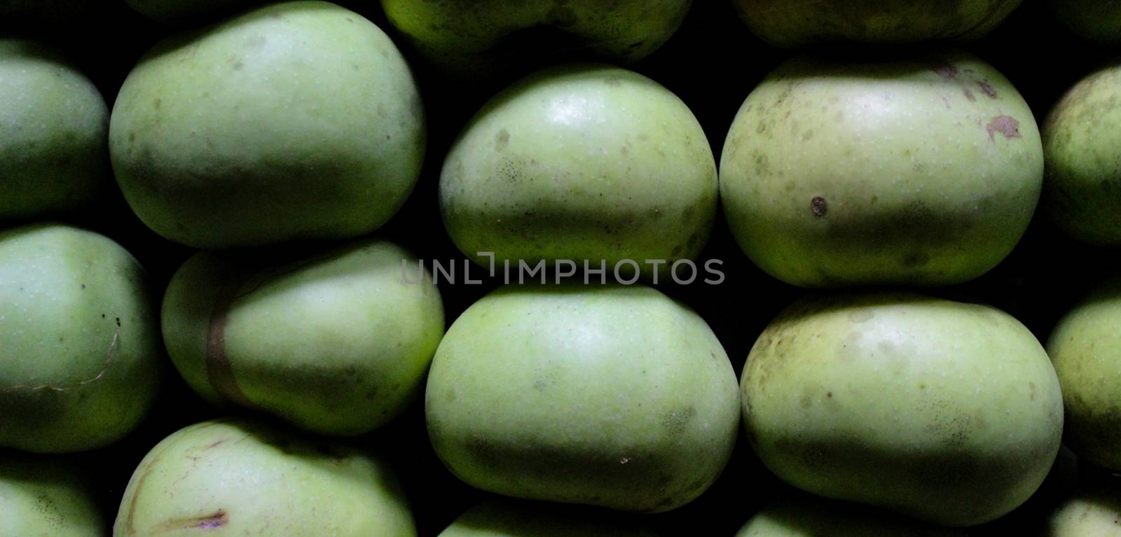 Banner of homemade apples of different sizes perfectly stacked in a crate. Apples in a crate in a storeroom in a dark room to keep them lasting longer. Variety Kanicka. by mahirrov