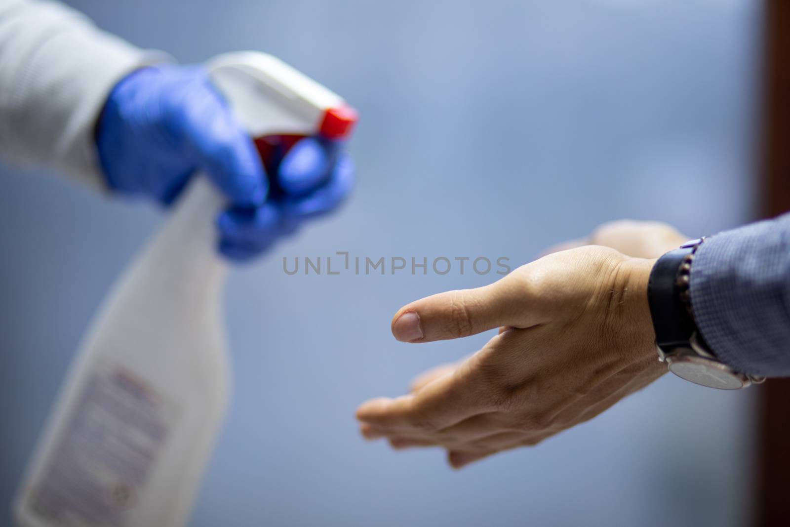 Spraying hands with antiseptic solution