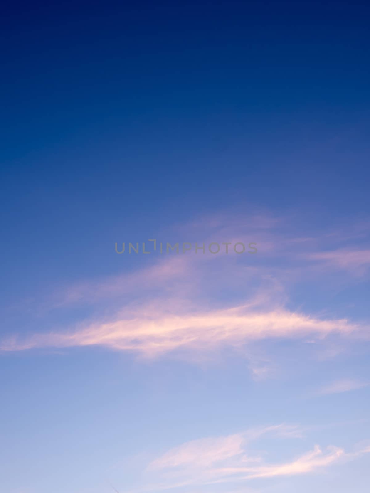 White fluffy clouds in the blue sky with morning light from the sunrise