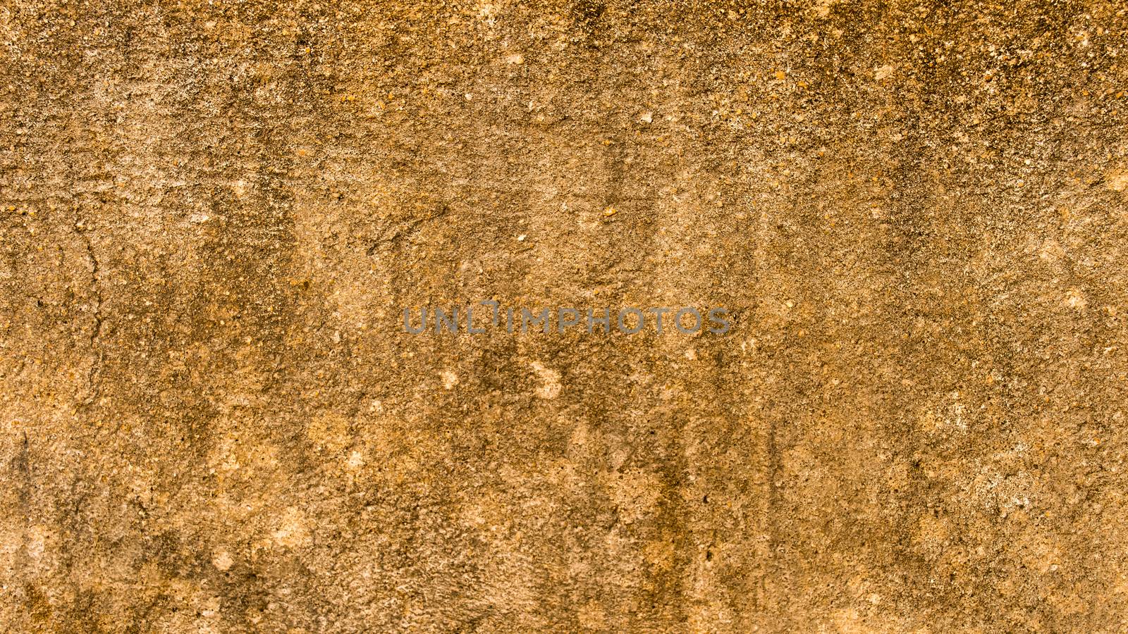 Close up Sand Wall Texture Pattern Beach Background design element. Sandy effects on sandstone plaster pillar with minor cracks and uneven patches highlighting Natural Yellow color shade. Copy Space by sudiptabhowmick