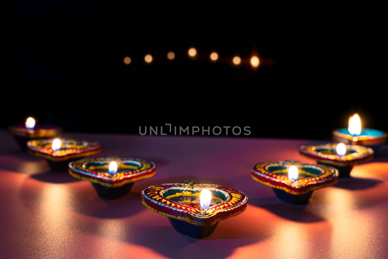 Indian festival Diwali, Diya oil lamps lit on colorful rangoli. Hindu traditional. Happy Deepavali. Copy space for text.