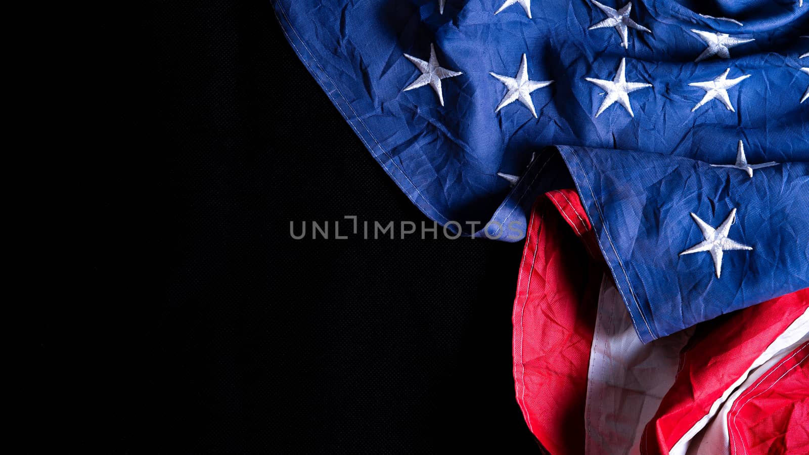 US American flag against black background. For Memorial, Presidents, Veterans, Labor, Independence or 4th of July celebration day. Top view, copy space for text. by mikesaran