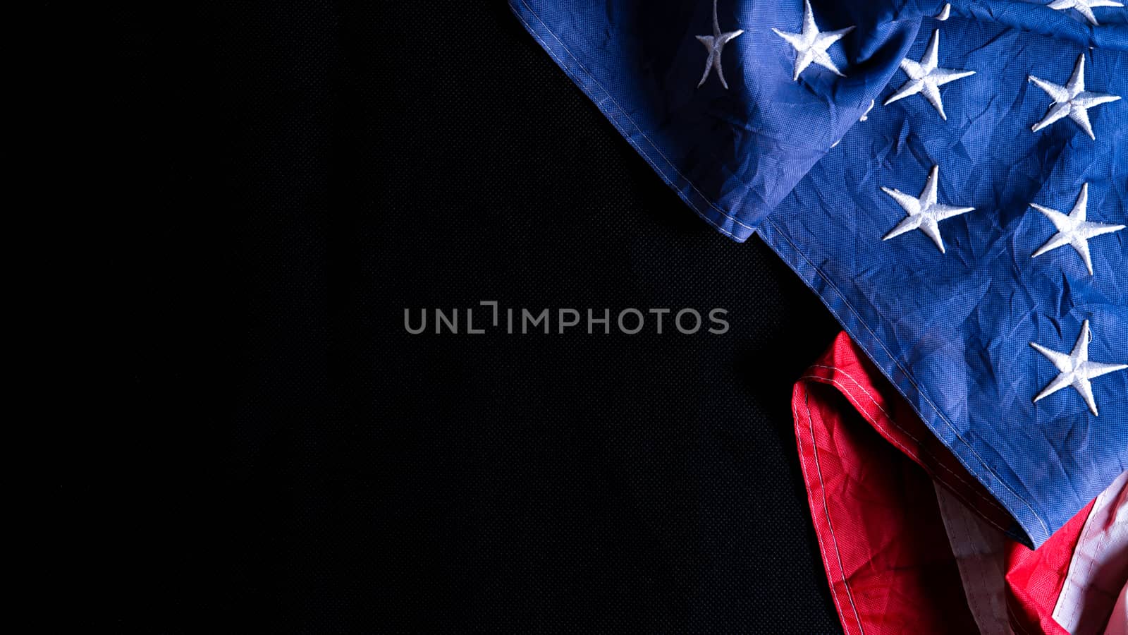 US American flag against black background. For Memorial, Presidents, Veterans, Labor, Independence or 4th of July celebration day. Top view, copy space for text.