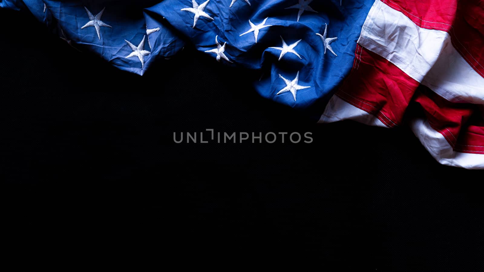 US American flag against black background. For Memorial, Presidents, Veterans, Labor, Independence or 4th of July celebration day. Top view, copy space for text.