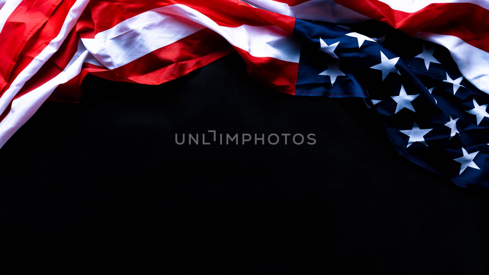 US American flag against black background. For Memorial, Presidents, Veterans, Labor, Independence or 4th of July celebration day. Top view, copy space for text.