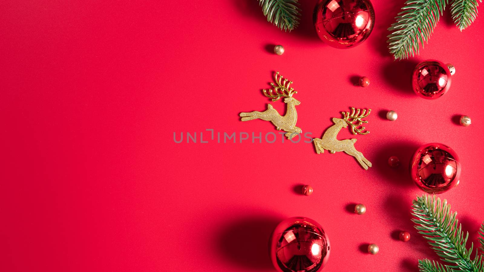 Christmas background. Top view of Christmas decorations on red background with copy space for text. Flat lay, winter, postcard template, new year concept. by mikesaran