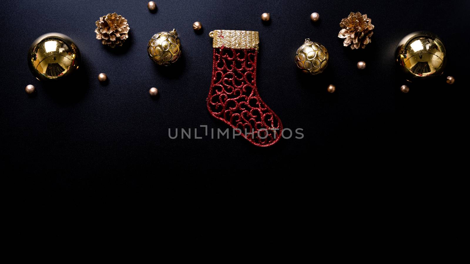 Christmas background. Top view of Christmas decorations on black background with copy space for text. Flat lay, winter, postcard template, new year concept. by mikesaran