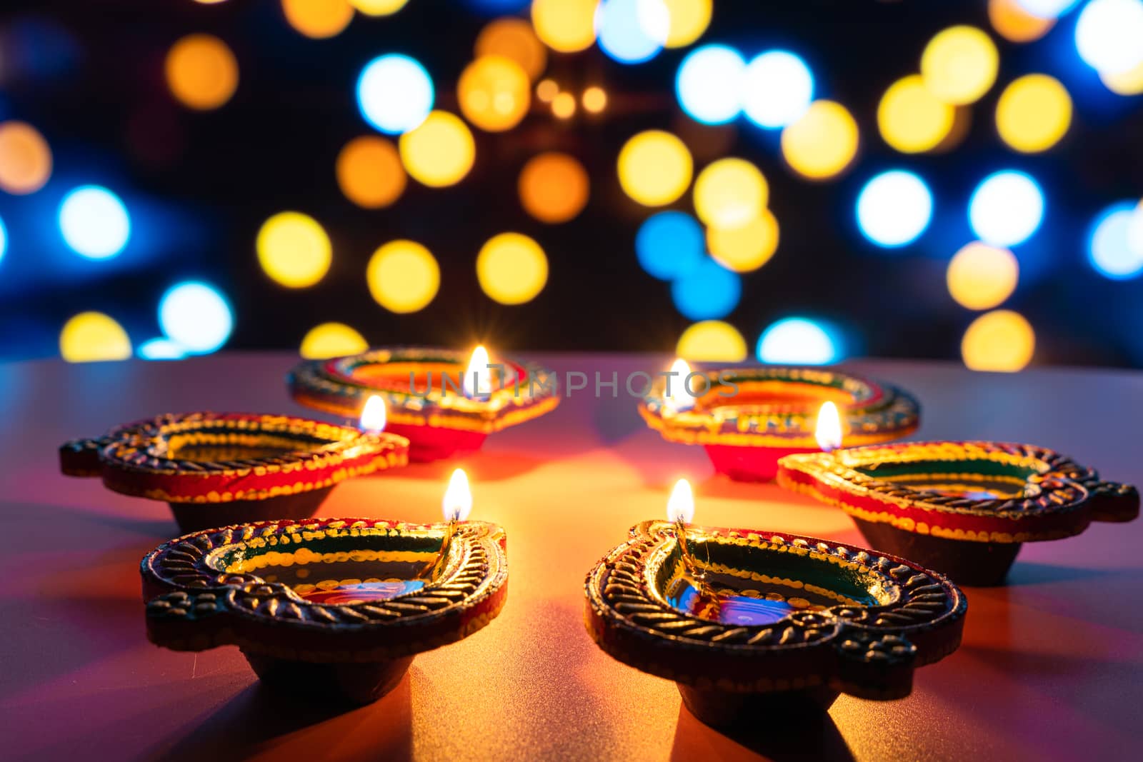 Indian festival Diwali, Diya oil lamps lit on colorful rangoli. Hindu traditional. Happy Deepavali. Copy space for text. by mikesaran