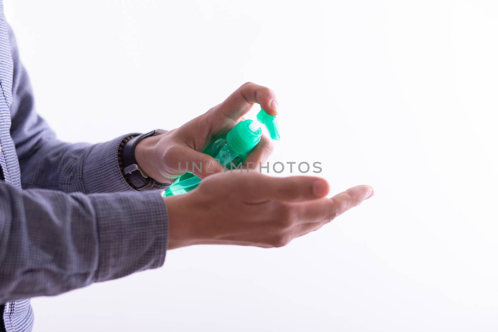 Man applying disinfectant alcohol gel on hands by adamr