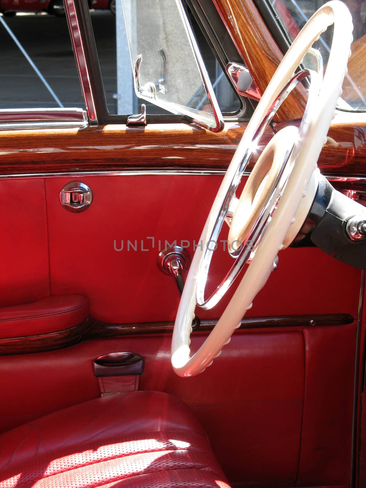 Antique car with red leather interior.